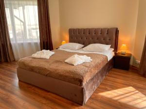Postel nebo postele na pokoji v ubytování SPA&Hotel MŪSA PARADISE