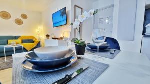 stół z talerzami i kieliszkami do wina w obiekcie Le SMART - Parking - Terrasse - Wifi - Mulhouse - Relax BNB w mieście Pfastatt