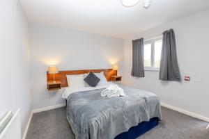 a bedroom with a bed and a window at The Angel Hotel in Alton