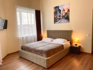 Postel nebo postele na pokoji v ubytování SPA&Hotel MŪSA PARADISE