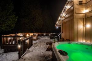 a snowy backyard with a hot tub in the snow at Red Rock Falls Cabin, 8 miles from Yosemite South Gate, with trailhead, Game Room and HotTub in Oakhurst