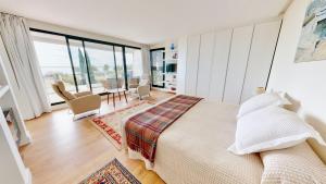 a bedroom with a large bed and a dining room at Villa Lili in L'Ampolla +47 photos