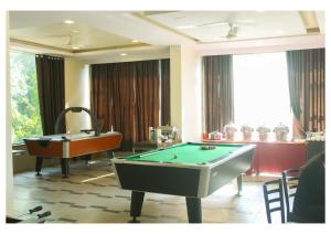 a room with a pool table and a tub at Hotel Lalit inn in Lonavala