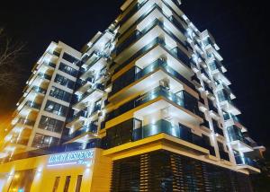 a tall building at night with its lights on at CSO Luxury Residence in Mamaia