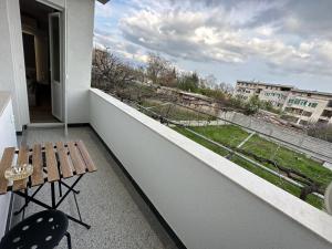 a balcony with a bench and a view of a city at Utopia Apartment 1, by LMG in Hisarya