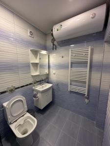 a bathroom with a toilet and a sink at Utopia Apartment 1, by LMG in Hisarya