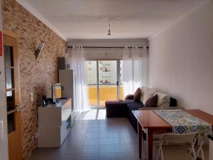 a living room with a couch and a table at Alltravel Columbia apartment in Portimão