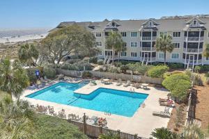 an overhead view of a swimming pool at a resort at Port O' Call E302 - Top Floor Ocean View Condo! in Isle of Palms