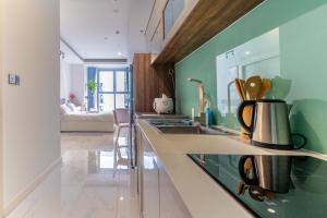 a kitchen with a sink and a counter top at De Lux Central Studio next Hyatt ,Opera House ,Benthanh ,Pool,Gym in Ho Chi Minh City