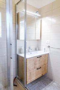 a bathroom with a sink and a shower at Apartments Mirela in Koper