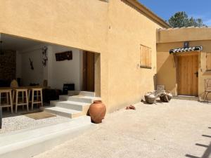 a house with stairs and a patio with a table at Villa Trap in Guadalix de la Sierra