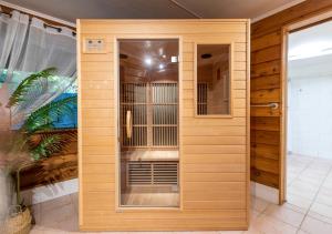 a wooden enclosure with a bird cage in a room at The Forest Buré - Fijian Hinterland Retreat in Ninderry