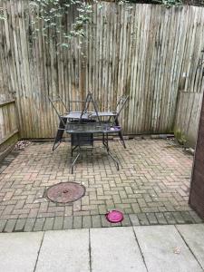 a picnic table in front of a wooden fence at Southend Lane Suites in Forest Hill