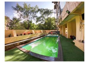 a swimming pool on the side of a building at Hotel Lalit inn in Lonavala