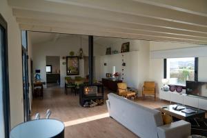 a living room with a couch and a fireplace at Casa do Carvalhal - Quinta do Soldado in Alquerubim