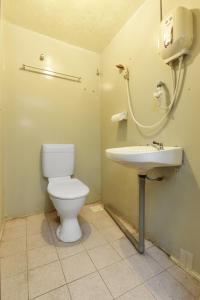 a bathroom with a toilet and a sink at OYO 90627 Pulau Ketam Inn in Klang