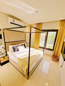 een slaapkamer met een groot bed in een kamer bij Jebel Sifah Suites in As Sīfah