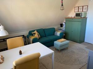 a living room with a couch and a table at Rose Cottage B&B in Nes