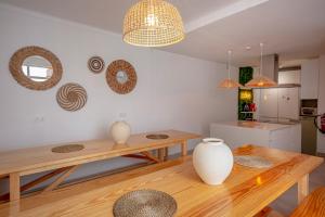 a dining room with a table and vases on the wall at Sun Lovers Hostel in Albufeira