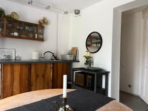 a dining room with a table and a mirror at Apartamenty Miły - Gdynia Redłowo in Gdynia