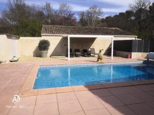 a swimming pool in front of a house at La maison de Marie Hélène 2 piscine partagée in Aix-en-Provence