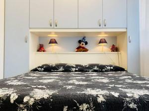 a bedroom with a bed with white cabinets at Residence Apuamare in Pietrasanta