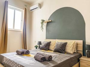 a bedroom with a large bed with a large window at Spacious 1 bedroom apartment in Gzira 5 in Il-Gżira