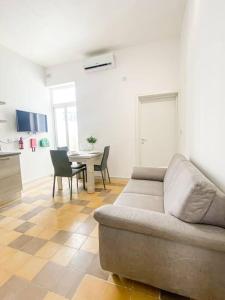 a living room with a couch and a table at Spacious 1 bedroom apartment in Gzira 5 in Il-Gżira