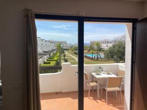 a view of a balcony with a table and chairs at Condado de Alhama Murcia in Alhama de Murcia