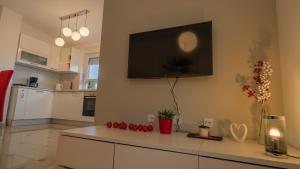 a living room with a flat screen tv on the wall at Sea & Sun 4* in Banjole +26 photos