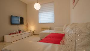 a living room with a couch and a flat screen tv at Sea & Sun 4* in Banjole