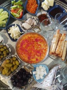 a table with a bunch of different types of food at MJORA Bungalov Ayder in Güroluk