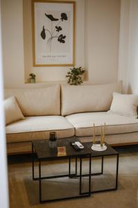 a living room with a couch and a coffee table at LB Luxury Apartments in Volos