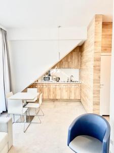 a living room with a blue chair and a table at Blueberry Mountain Czarna góra in Biała Woda