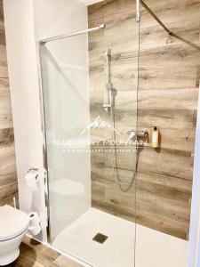 a shower with a glass door in a bathroom at Blueberry Mountain Czarna góra in Biała Woda