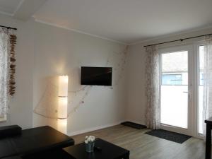a living room with a tv on the wall at Ferienwohnung zur Ostsee 3 in Zinnowitz