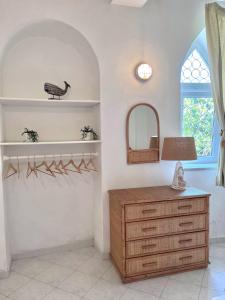 a dressing room with a dresser and a mirror at Villa Izzo in Ischia