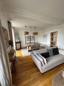 een woonkamer met een bank en een tafel bij Appartement Enghien-les-Bains in Enghien-les-Bains