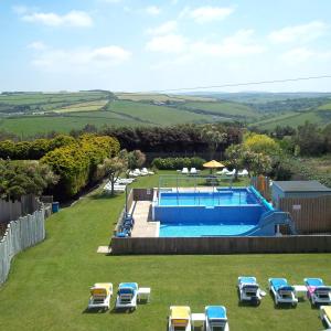 an overhead view of a swimming pool in a lawn with chairs at Sands Resort Hotel in Newquay