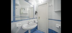 a white bathroom with a sink and a mirror at Villa Izzo in Ischia +82 photos