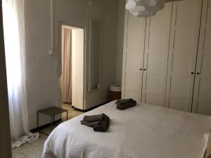 a bedroom with a large white bed with towels on it at Bixio 81 in Parma