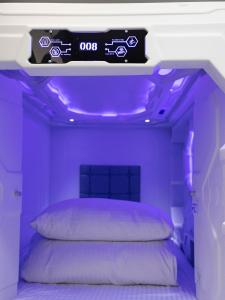 a purple bedroom with a bed with a sign above it at Planet 23 in Chiayi City