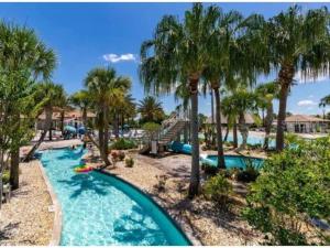 a pool at the resort with palm trees at Luxury Champions Gate Condo-Disney Firework Views! in Kissimmee