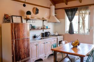 een keuken met een tafel en een houten koelkast bij Apartamentos Chill in El Bolsón