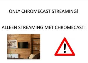 a screenshot of a living room with a sign that reads only champagnefast streaming alert at Luxe Chalets in Zeeland aan de kust in Sint Annaland