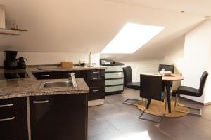 a kitchen with a sink and a table at Baumeister`s Ferienwohnung 