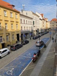 ulica miejska z samochodami zaparkowanymi na ulicy w obiekcie Szymborska Apartamenty Mostowa 18-2 w Toruniu