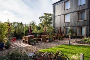 a garden with tables and chairs next to a building at Mollie's Motel & Diner Bristol in Bristol