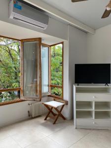 uma sala de estar com uma televisão de ecrã plano e uma janela em Posada de San Isidro em San Isidro