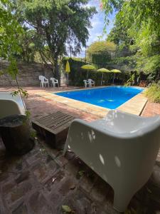 a white tub sitting next to a swimming pool at Posada de San Isidro in San Isidro